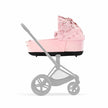PRIAM Lux Gen 4 Simply Flowers Carry Cot in Pale Blush on stroller frame.