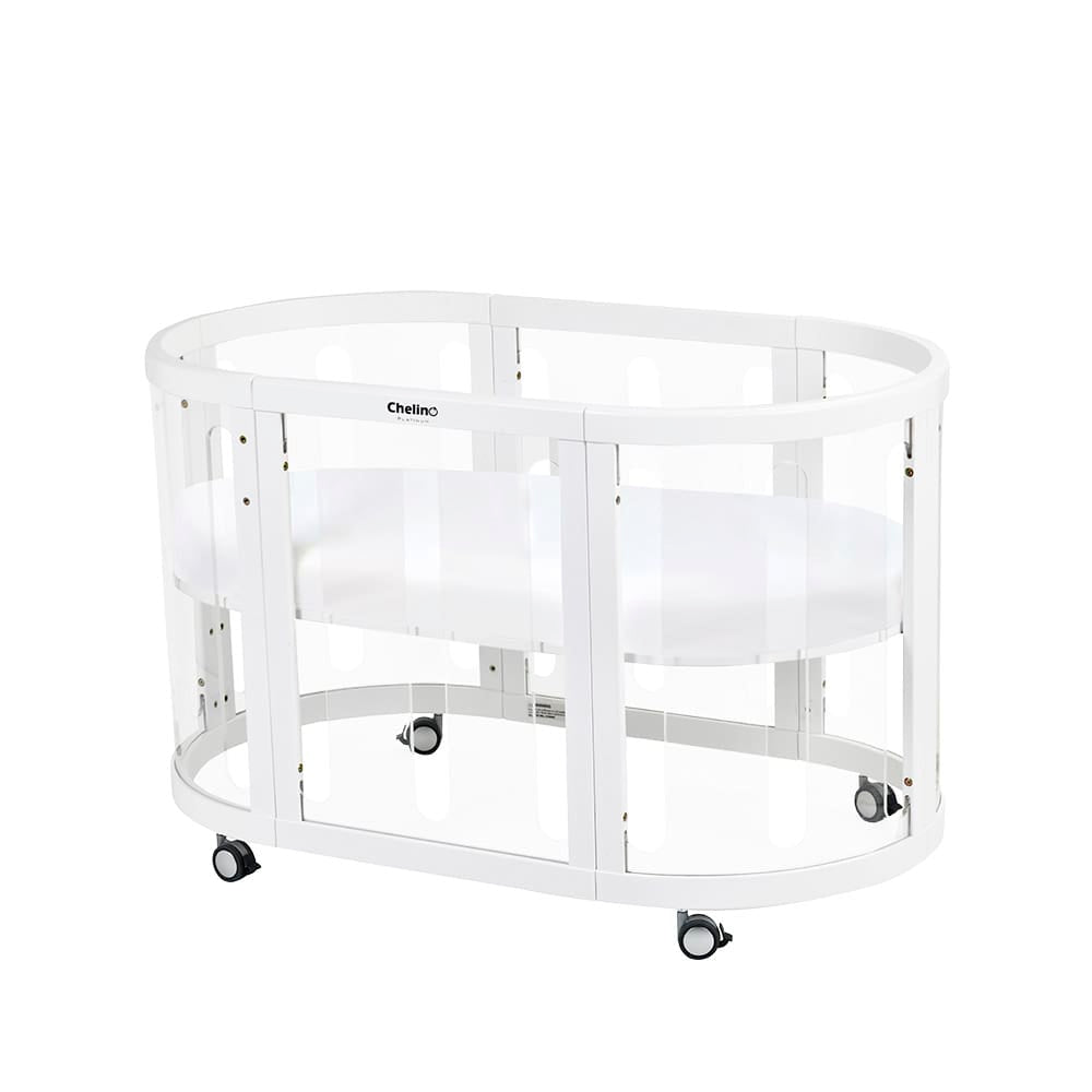 Selina 5 in 1 Cot White with clear panels and wheels, made from sustainable oak wood.