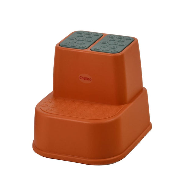 Pink footstool for toddlers with buttoned grip for stability and safety.