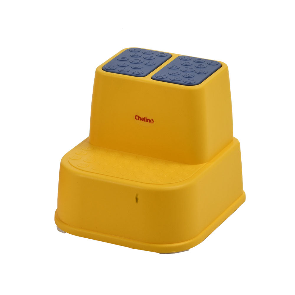 Yellow footstool with buttoned grip for toddler safety.