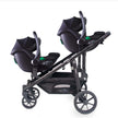 Deuce Twin Travel System with two Aton B2 i-Size car seats attached to stroller.