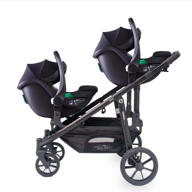 Deuce Twin Travel System with two Aton B2 i-Size car seats attached to stroller.