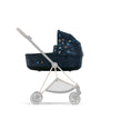 MIOS LUX Carry Cot Jewels of Nature attached to stroller frame in side view.