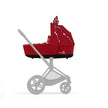PRIAM/e-PRIAM Lux Carry Cot by Jeremy Scott with PettiCoat design in red, shown on a stroller chassis.