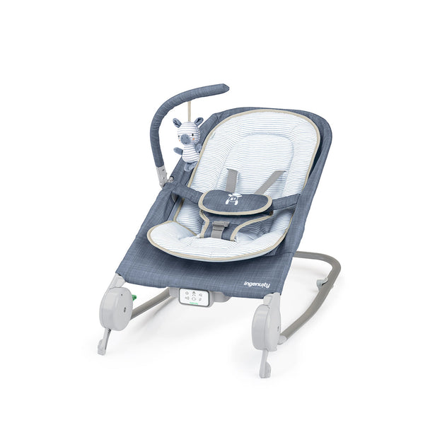 Ingenuity Happy Belly Rock-to-Bounce massage seat in chambray with plush insert, 5-point harness, detachable zebra toy, and control pad for melodies and massage.