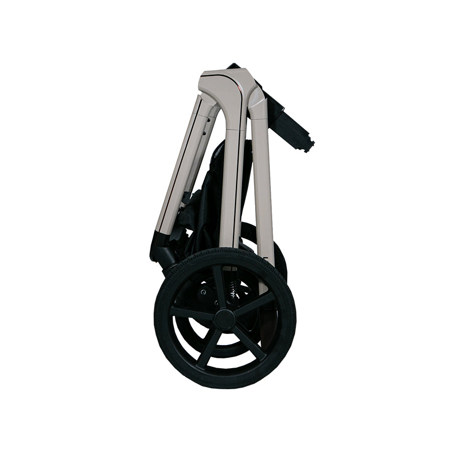 Lunar II Travel System in beige, folded, showcasing compact design and wheels.