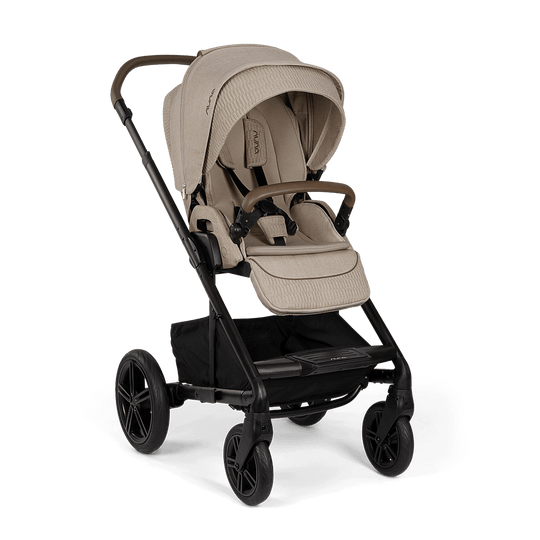 NUNA MIXX™ NEXT STROLLERS stroller in taupe fabric with a padded seat, adjustable canopy, black frame, and storage basket.