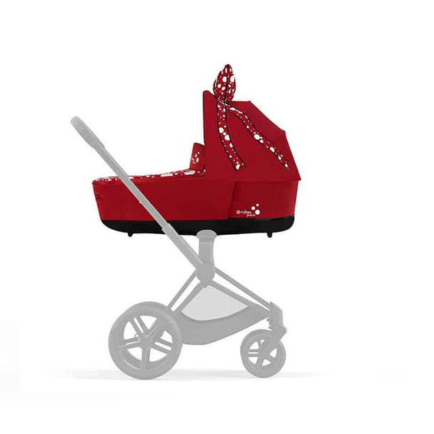PRIAM/e-PRIAM Lux Carry Cot by Jeremy Scott with PettiCoat design in red, shown on a stroller chassis.