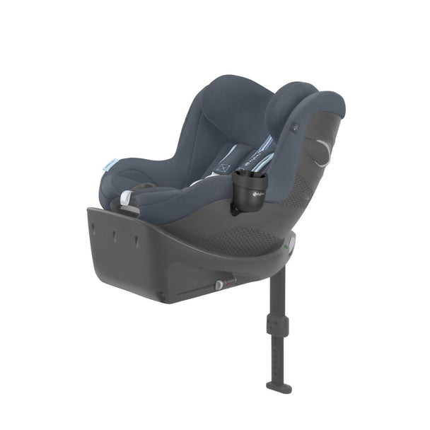 Cybex car seat with attached cup holder for child drinks.
