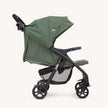 Joie Muze™ lx stroller with a sage green fabric canopy and seat, black frame, mesh basket and four wheels