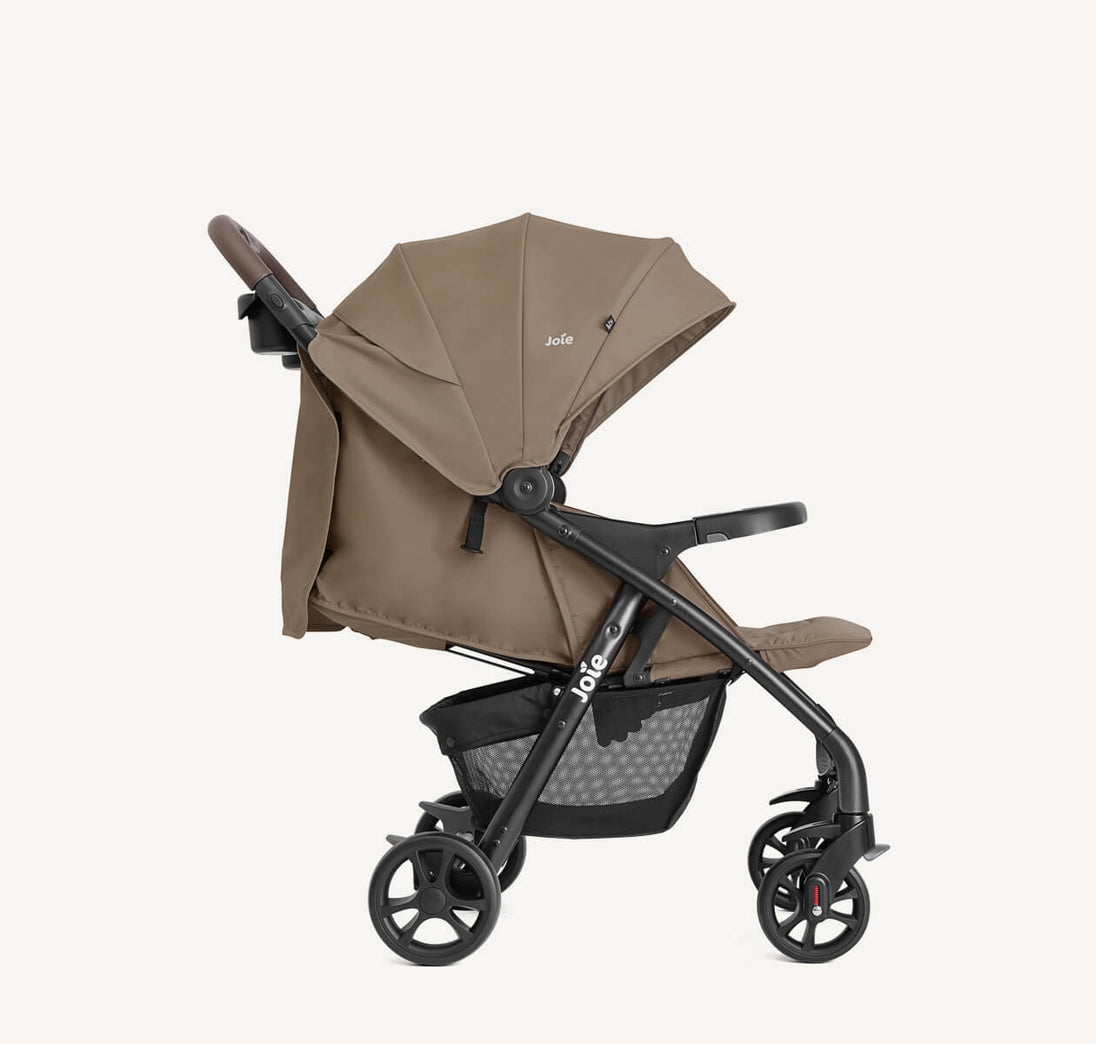 Joie Muze™ lx stroller in taupe fabric with a black frame, extended canopy, padded seat and storage basket